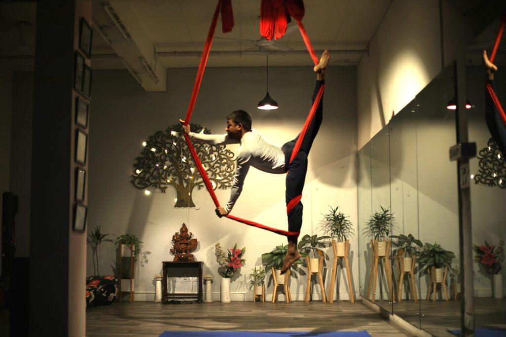 A perosn doing an Aerial Yoga Pose on Aerial Hammock