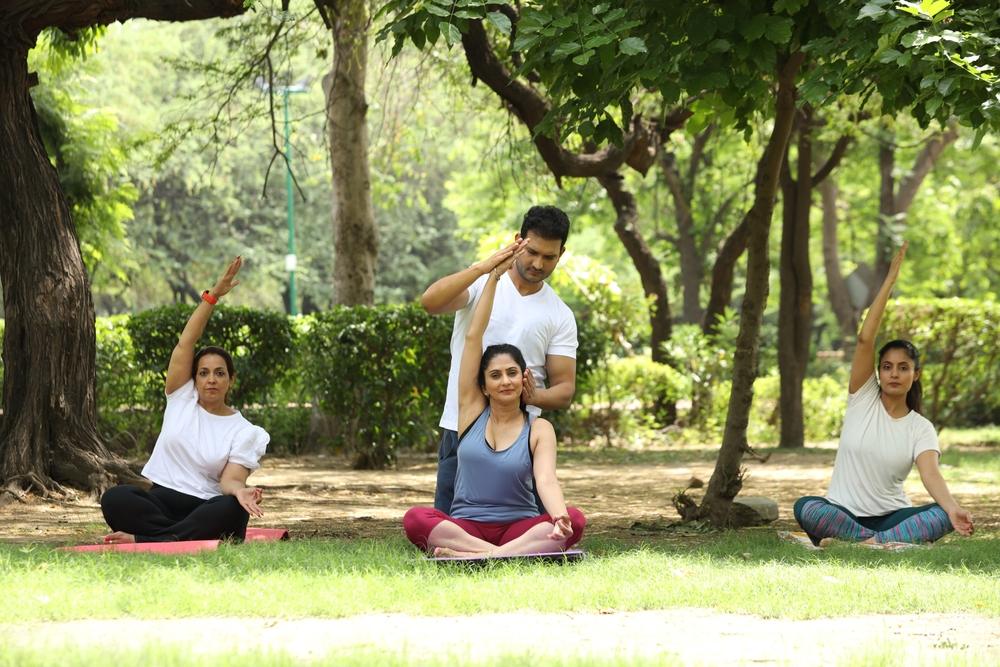 Indian Male teacher Teaching Yoga