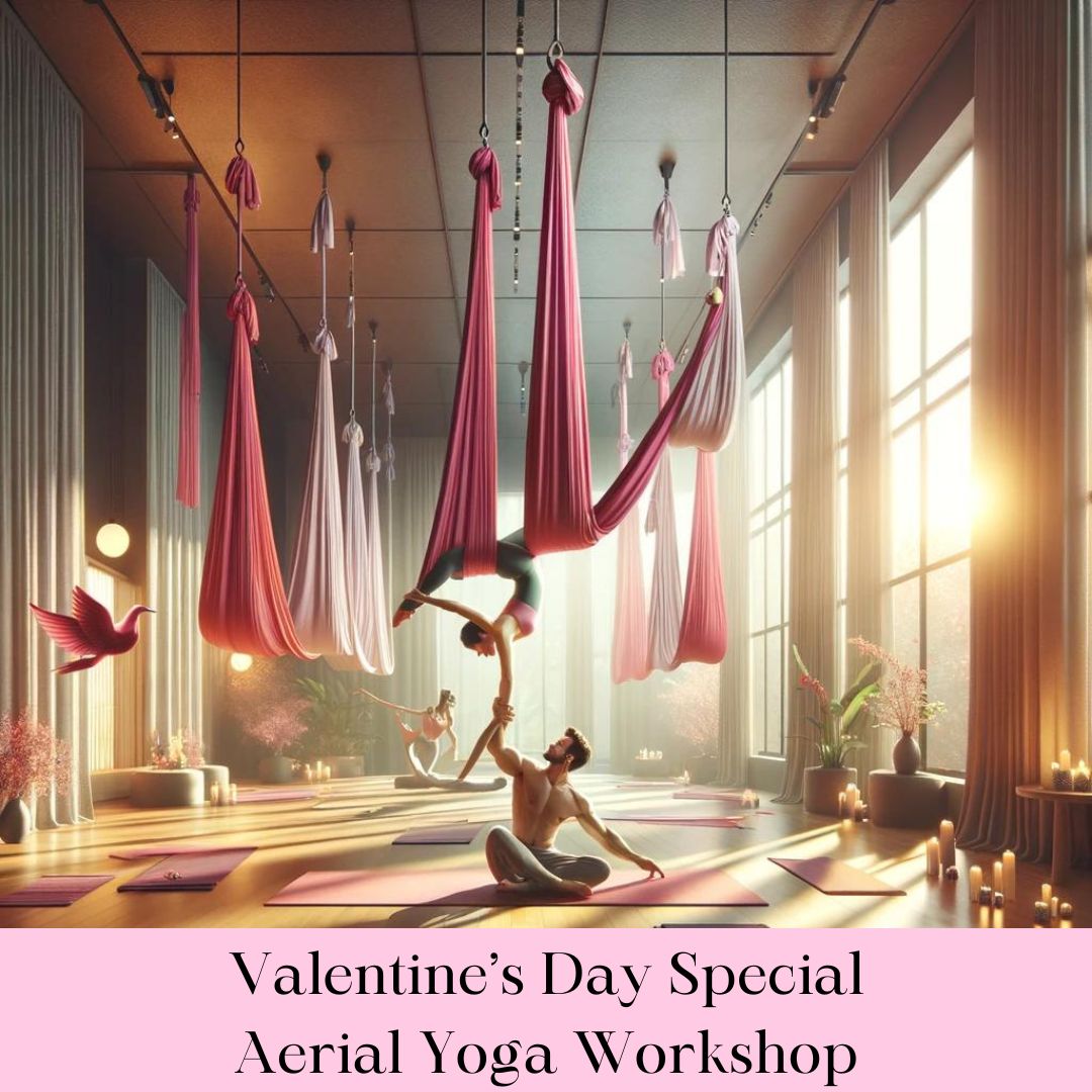 A couple practicing aerial yoga in a serene studio decorated for Valentine's Day, symbolizing love and connection through vibrant pink silks.