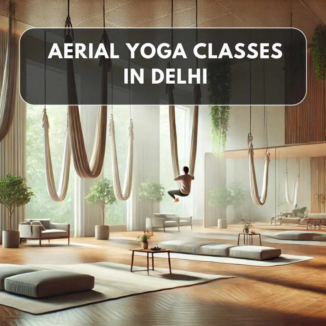 A peaceful and modern aerial yoga studio featuring silk hammocks suspended from the ceiling. The space is filled with natural light, wooden flooring, and touches of greenery. A person is gracefully performing an aerial yoga pose, showcasing focus and elegance in a calm, professional environment.