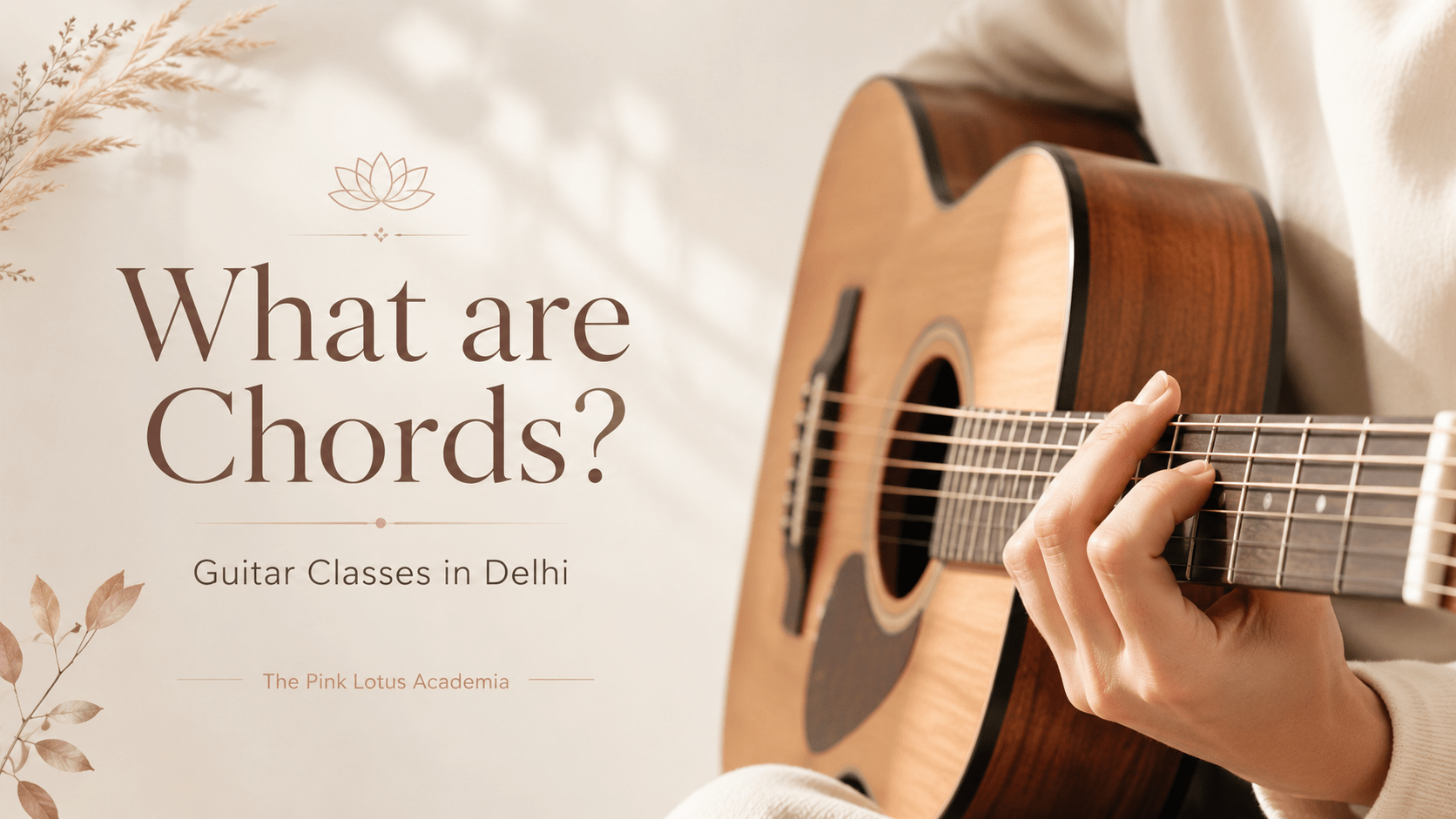 Aesthetic acoustic guitar image showing a student playing chords for Guitar Classes in Delhi by The Pink Lotus Academia.