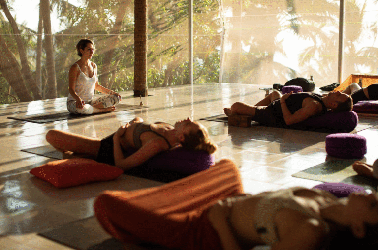 Yoga practitioner meditating in a peaceful studio, representing YTTC in India with The Pink Lotus Academia.